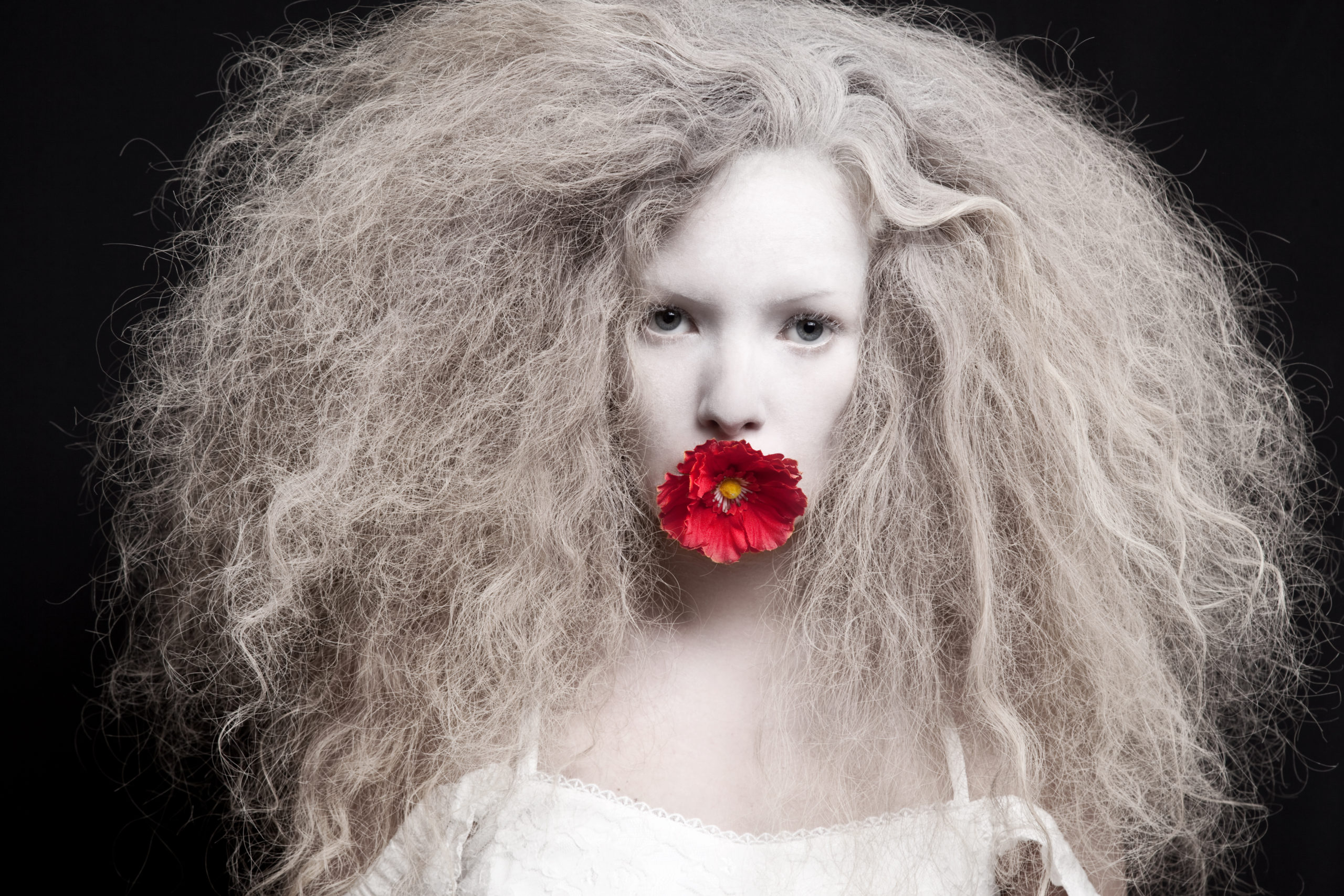 Woman with red flower on mouth